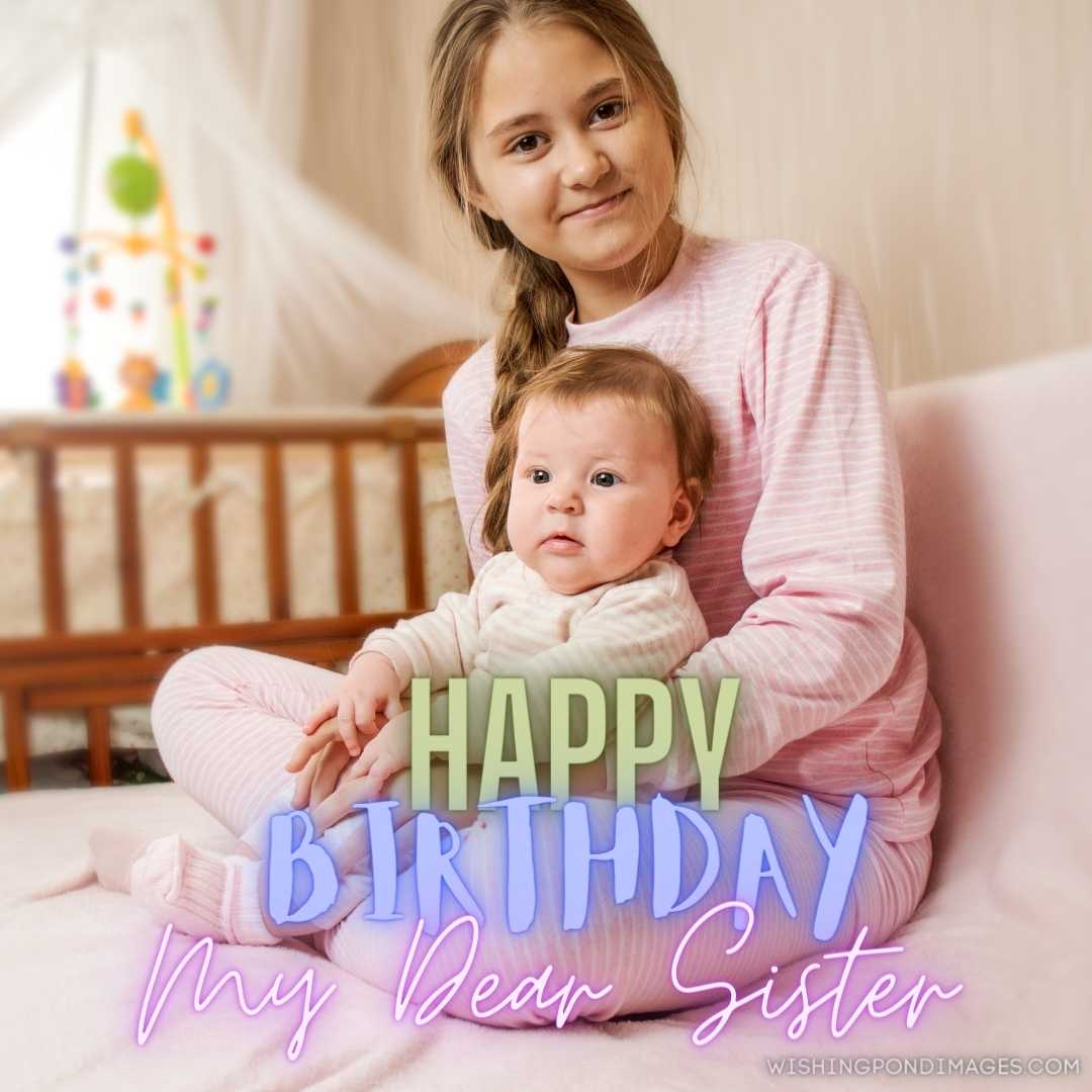 Elder sister holds the baby sister in her arms. Happy Birthday Sister Images